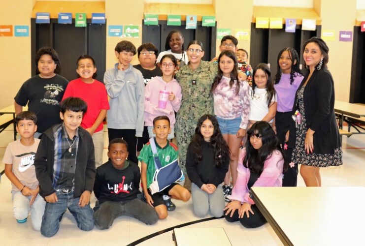 Ms. Guerrero poses with Ms. Schinke's 5th grade class.